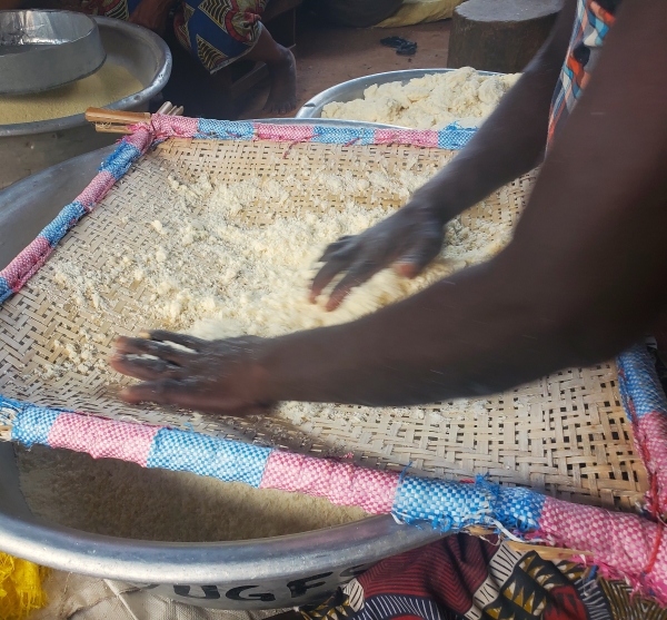  Fermented, ground cassava is sifted before the roasting stage of Gari Sohoui; photo provided.
